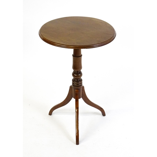 1609 - A mahogany tripod occasional table with a circular moulded top above a turned pedestal and raised on... 