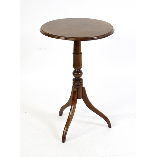 1609 - A mahogany tripod occasional table with a circular moulded top above a turned pedestal and raised on... 