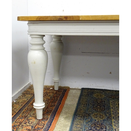 1615 - A late 20thC dining / refectory table with a planked top above a painted base and four baluster turn... 