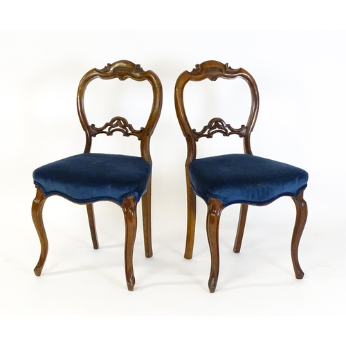 1616 - A pair of 19thC walnut balloon back dining side chairs with carved, pierced mid rails and raised on ... 