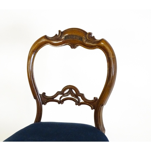 1616 - A pair of 19thC walnut balloon back dining side chairs with carved, pierced mid rails and raised on ... 