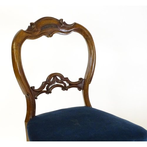 1616 - A pair of 19thC walnut balloon back dining side chairs with carved, pierced mid rails and raised on ... 