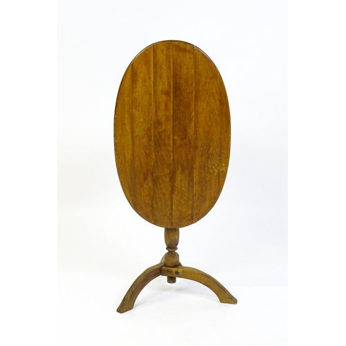 1621 - An early 20thC New England style occasional table, with an oval planked top, a storage compartment b... 