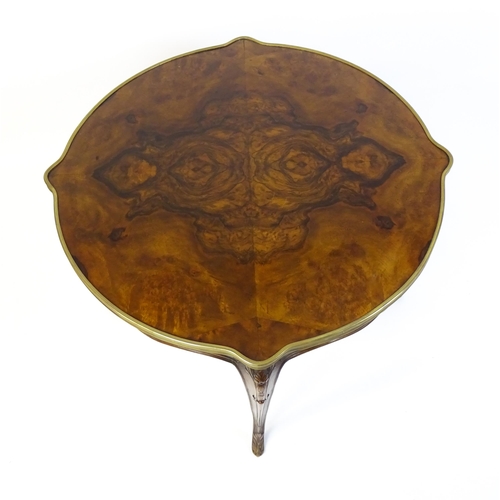 1623 - A Louis XV style centre table with a brass surround and a burr walnut veneered top above four carved... 