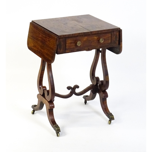 1626 - A 19thC rosewood work table / writing table with drop flaps to either side and two lyre shaped suppo... 