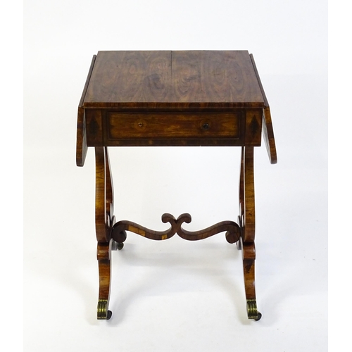 1626 - A 19thC rosewood work table / writing table with drop flaps to either side and two lyre shaped suppo... 