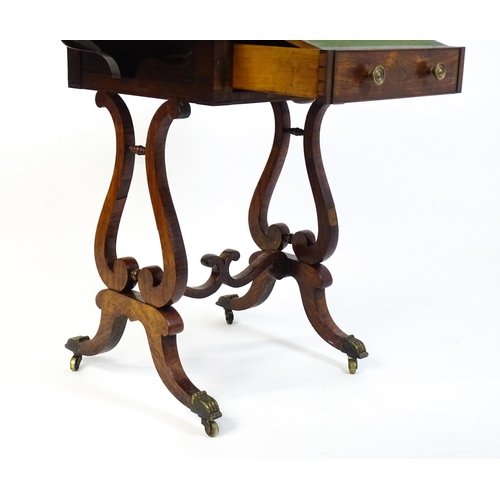 1626 - A 19thC rosewood work table / writing table with drop flaps to either side and two lyre shaped suppo... 