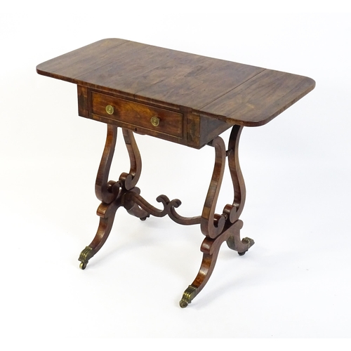 1626 - A 19thC rosewood work table / writing table with drop flaps to either side and two lyre shaped suppo... 