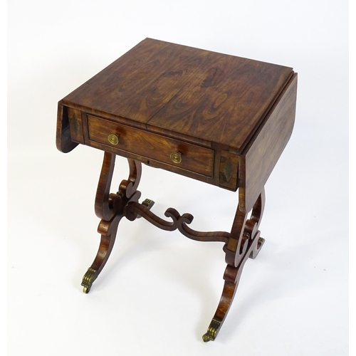 1626 - A 19thC rosewood work table / writing table with drop flaps to either side and two lyre shaped suppo... 