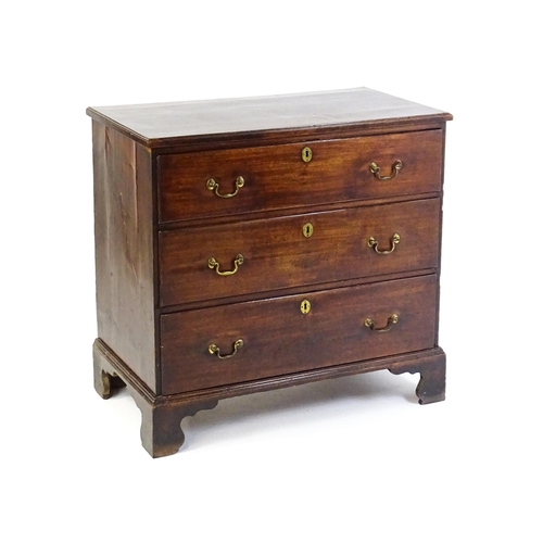 1633 - A late 18thC / early 19thC mahogany chest of drawers comprising a rectangular moulded top above thre... 