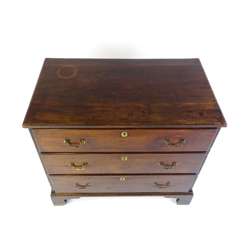 1633 - A late 18thC / early 19thC mahogany chest of drawers comprising a rectangular moulded top above thre... 