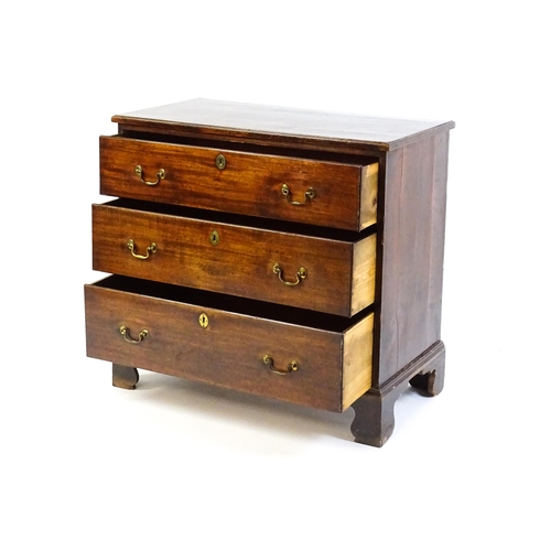 1633 - A late 18thC / early 19thC mahogany chest of drawers comprising a rectangular moulded top above thre... 