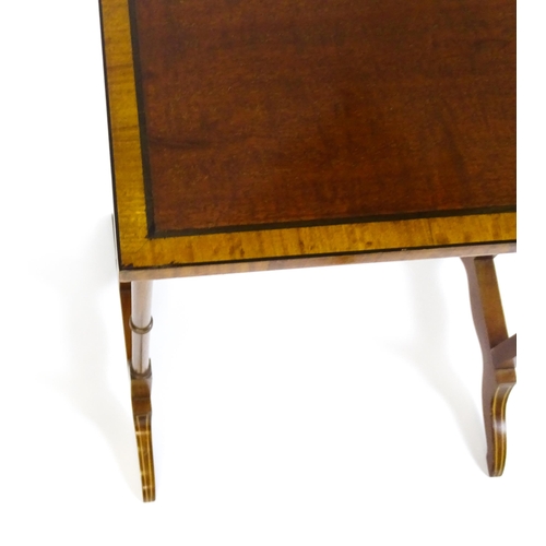 1634 - A nest of four early 20thC tables with crossbanded mahogany tops raised on turned tapering legs and ... 