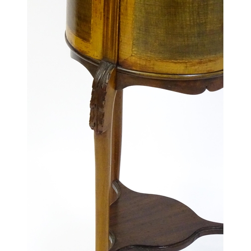 1638 - An early 20thC mahogany jardinière with a barrel top raised on three carved cabriole legs united by ... 