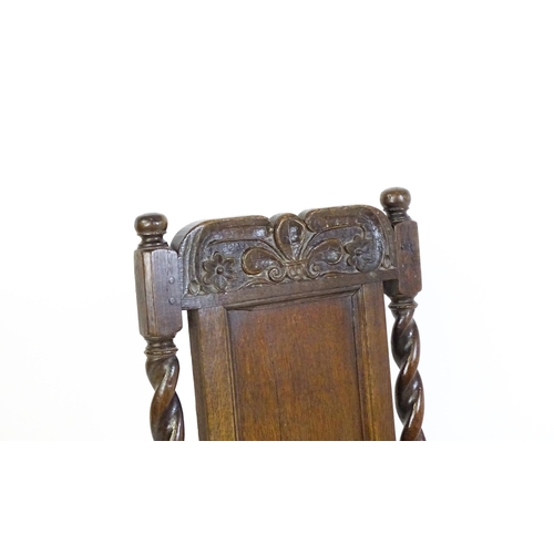 1639 - A late 17thC oak back stool with a carved cresting rail and turned uprights alongside a panel back a... 