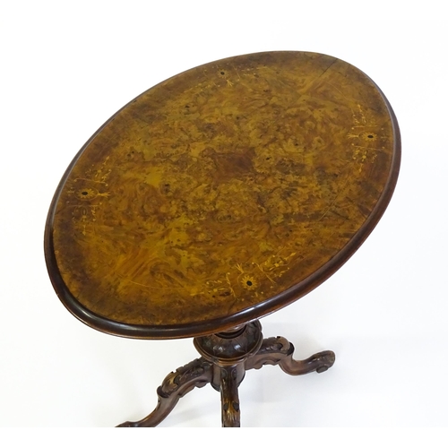 1650 - A late 19th / early 20thC walnut occasional table with an oval burr walnut top and a satinwood marqu... 