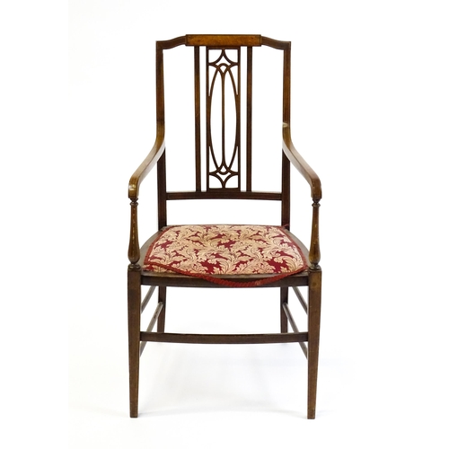 1652 - An Edwardian elbow chair with a burr walnut veneered top rail, a pierced back splat and swept arms o... 