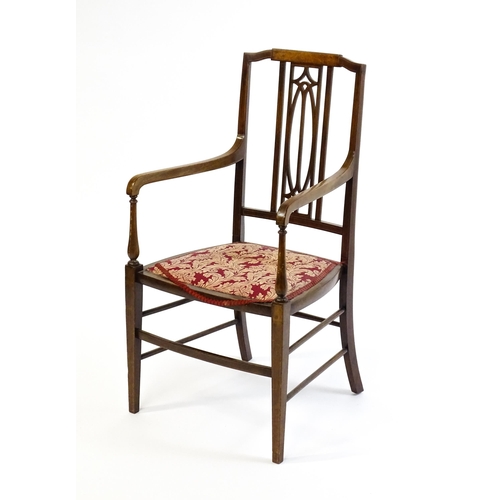 1652 - An Edwardian elbow chair with a burr walnut veneered top rail, a pierced back splat and swept arms o... 