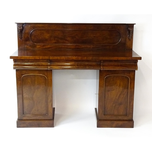 1653 - A Victorian mahogany double pedestal sideboard with a panelled upstand, acanthus carved brackets and... 