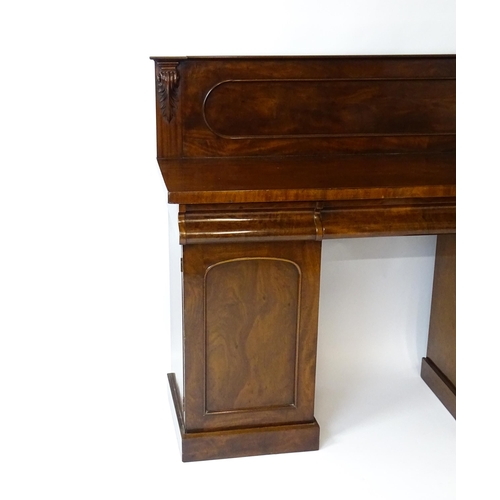 1653 - A Victorian mahogany double pedestal sideboard with a panelled upstand, acanthus carved brackets and... 