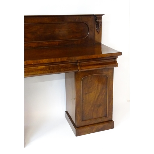 1653 - A Victorian mahogany double pedestal sideboard with a panelled upstand, acanthus carved brackets and... 