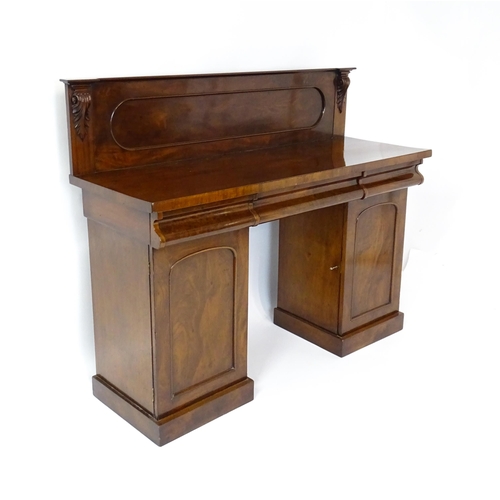 1653 - A Victorian mahogany double pedestal sideboard with a panelled upstand, acanthus carved brackets and... 