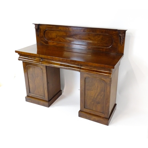 1653 - A Victorian mahogany double pedestal sideboard with a panelled upstand, acanthus carved brackets and... 