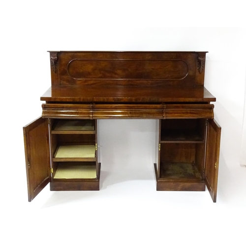 1653 - A Victorian mahogany double pedestal sideboard with a panelled upstand, acanthus carved brackets and... 