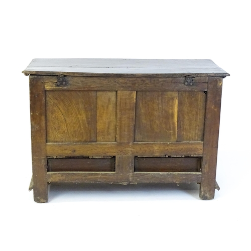 1654 - A late 17thC mule chest with a hinged lid above a planked top, panelled sides and geometric moulding... 