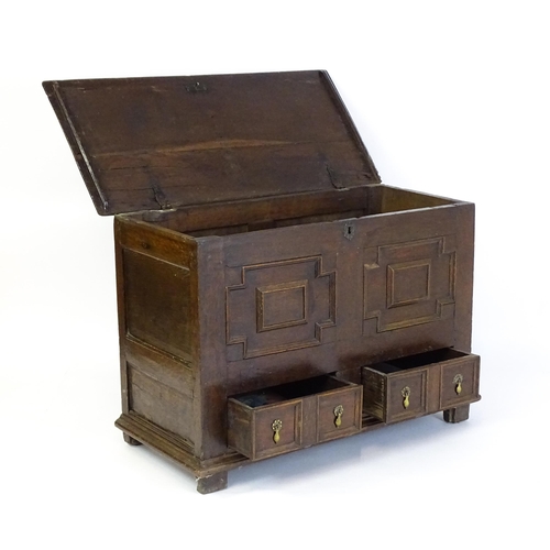 1654 - A late 17thC mule chest with a hinged lid above a planked top, panelled sides and geometric moulding... 