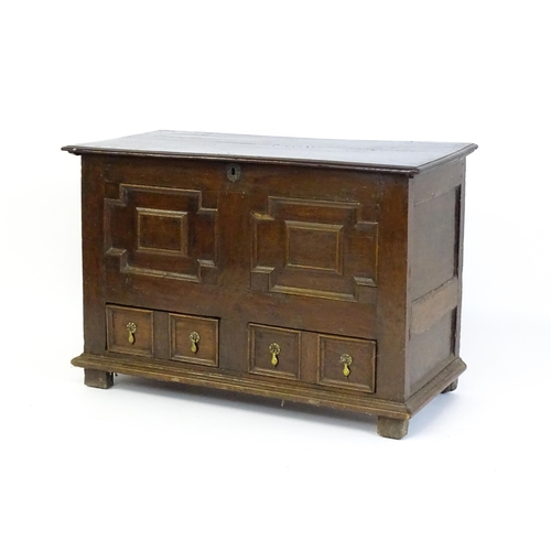 1654 - A late 17thC mule chest with a hinged lid above a planked top, panelled sides and geometric moulding... 