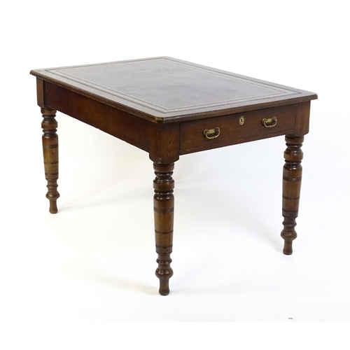 1655 - An early 20thC Trevor Page & Co of Norwich writing desk, with a gold tooled leather top above a sing... 