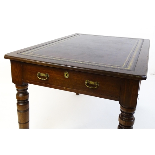 1655 - An early 20thC Trevor Page & Co of Norwich writing desk, with a gold tooled leather top above a sing... 