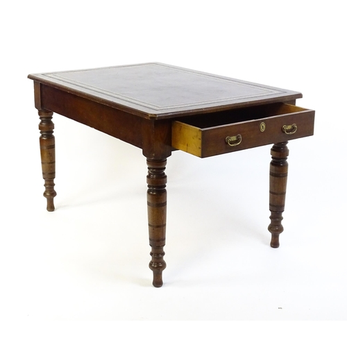 1655 - An early 20thC Trevor Page & Co of Norwich writing desk, with a gold tooled leather top above a sing... 