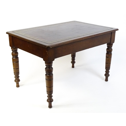 1655 - An early 20thC Trevor Page & Co of Norwich writing desk, with a gold tooled leather top above a sing... 