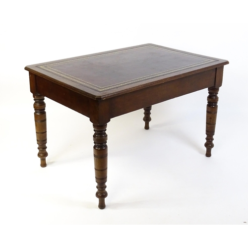 1655 - An early 20thC Trevor Page & Co of Norwich writing desk, with a gold tooled leather top above a sing... 