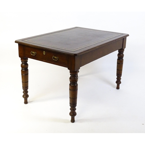 1655 - An early 20thC Trevor Page & Co of Norwich writing desk, with a gold tooled leather top above a sing... 