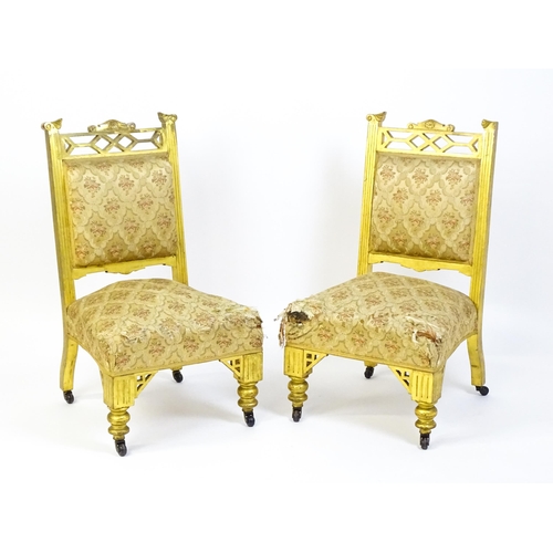 1656 - A pair of early 20thC giltwood nursing chairs with Anglo-Japanese pierced design elements and raised... 