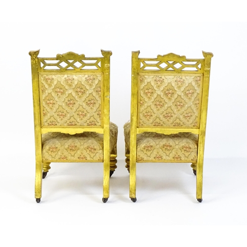 1656 - A pair of early 20thC giltwood nursing chairs with Anglo-Japanese pierced design elements and raised... 