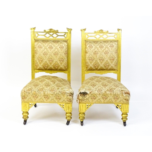 1656 - A pair of early 20thC giltwood nursing chairs with Anglo-Japanese pierced design elements and raised... 