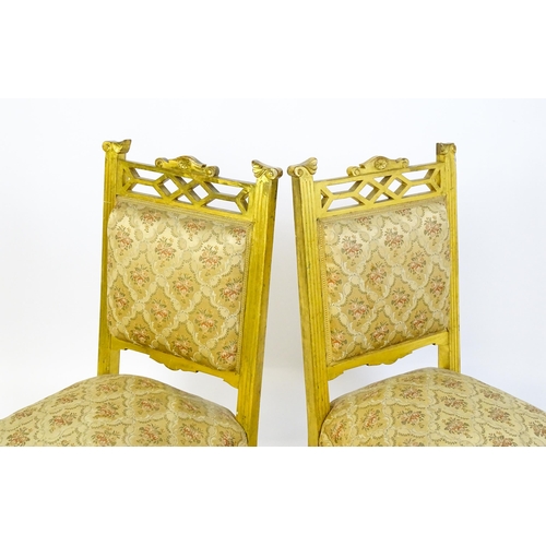 1656 - A pair of early 20thC giltwood nursing chairs with Anglo-Japanese pierced design elements and raised... 