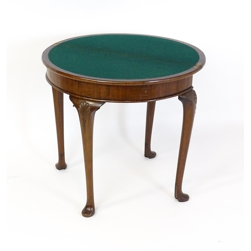 1660 - A 20thC mahogany demi lune card table with a hinged top opening to show a baize playing surface rais... 