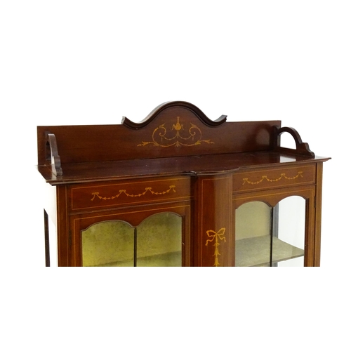 1670 - An Edwardian mahogany display cabinet with a shaped and moulded upstand, a satinwood inlaid frame wi... 