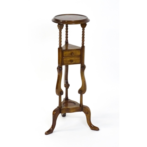 1671 - A mahogany washstand with a dished top above a triangular under tier with two short drawers, the sta... 