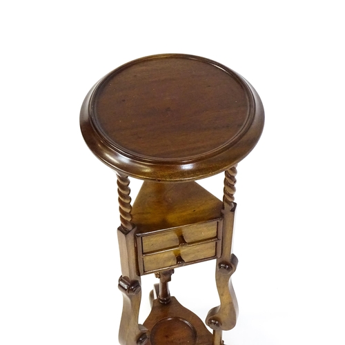 1671 - A mahogany washstand with a dished top above a triangular under tier with two short drawers, the sta... 