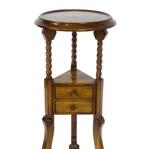 1671 - A mahogany washstand with a dished top above a triangular under tier with two short drawers, the sta... 