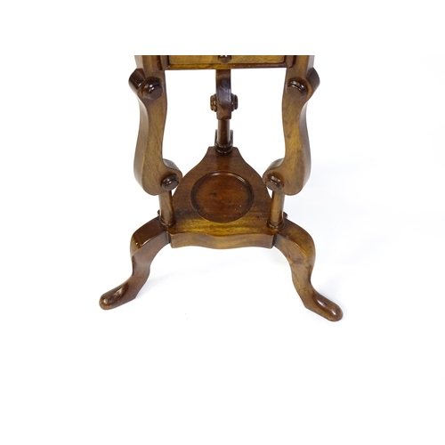 1671 - A mahogany washstand with a dished top above a triangular under tier with two short drawers, the sta... 