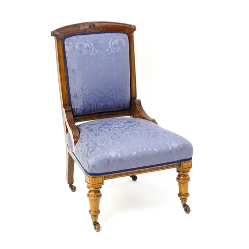 1680 - A late 19thC walnut nursing chair with a rosette carved top rail, and a sprung seat raised on turned... 