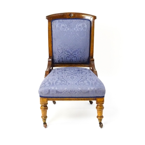 1680 - A late 19thC walnut nursing chair with a rosette carved top rail, and a sprung seat raised on turned... 