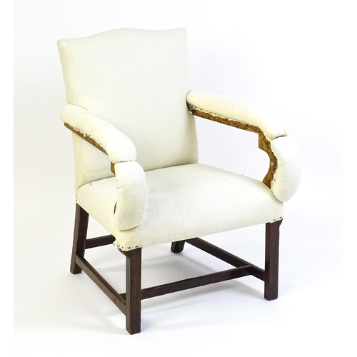 1681 - A Georgian library chair with unusual upholstered arms and raised on straight legs united by a H-str... 